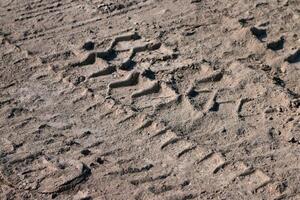 Track marks on loose soil after operating a crawler bulldozer photo