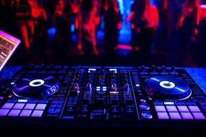 music controller DJ mixer in a nightclub at a party photo