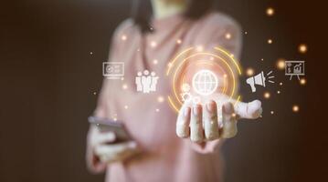 Digital media marketing in virtual screen concept. Businessman hand holding virtual globe, technology, communication, business world, IoT, internet network connection, artificial intelligence. photo