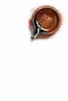Diwali Diya over brush strokes on white background. photo
