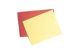 Blank yellow card on a vibrant red envelope for personal messages, invitations. Top view photo
