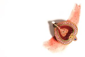 Hindu tradition Diwali diya oil lamps burning over paint stroke on white background. photo