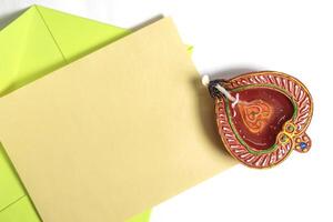 Happy Diwali celebration greeting card and clay diya lamp isolated on white background. photo