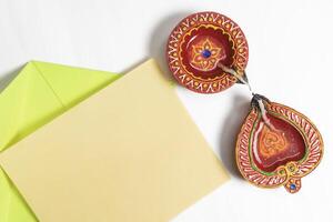 Diwali greeting card with festive diya lamp on white background. photo
