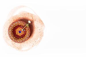 Happy Diwali - Close up of diwali diya lamp on white background with space for text. Hindu festival of lights. photo