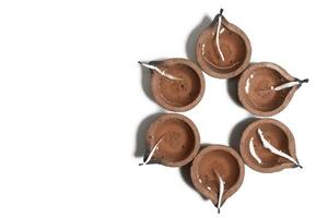 Hindu traditional clay diya arrangement for Diwali celebration on white background with copy space for text. photo