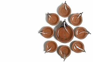 Hindu traditional clay diya arrangement for Diwali celebration on white background with copy space for text. photo
