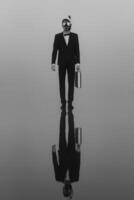 surreal portrait of a man in a suit and mask with a diving tube with a briefcase in his hands standing on the water photo