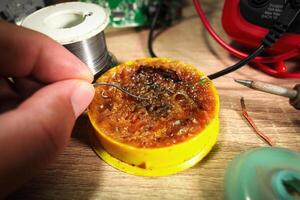 Close up of soldering paste or flux using by electrician for soldering lead , Electric appliance repair concept photo