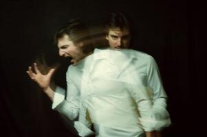 schizophrenic portrait of a psychopathic man with mental disorders in a white shirt photo