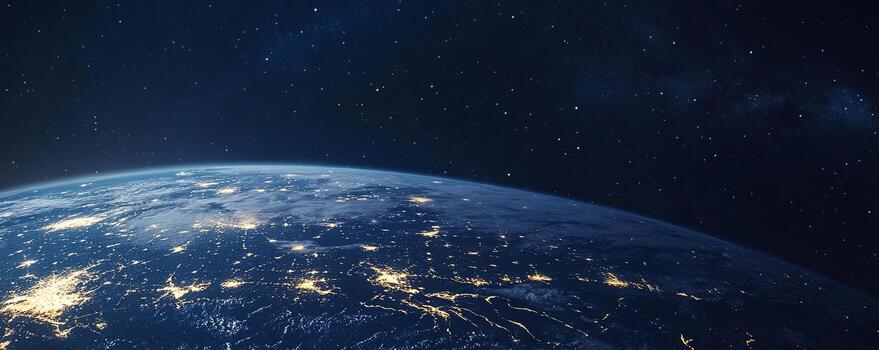 A view of Earth from space, with a dark blue sky and a starry background. The planet's surface is illuminated by city lights, highlighting the continents and oceans. photo