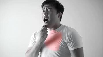 A man with a sore throat, coughing and holding his chest. He is in pain and suffering. photo