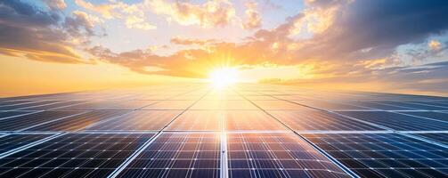 A vast field of solar panels stretches out under a beautiful sunset, with the sun shining brightly in the distance, offering a powerful visual representation of clean energy and a sustainable future. photo