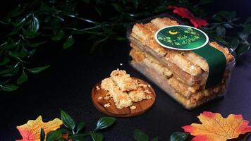 Premium cheese sticks with a savory and crispy flavor, neatly packed in an Eid-themed container, featuring a green Eid al-Fitr label and green leaf and red maple decorations. photo