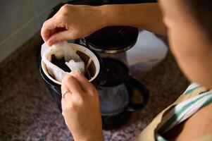Preparing coffee grounds in a filter for brewing delicious coffee photo