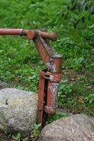 a red fire hydrant sitting on a rock photo