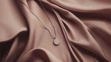 Minimalist Silver Necklace with Round Pendant on Soft Fabric Background photo