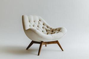 Chic modern chair with button tufts and angular wooden legs isolated photo