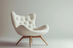 Chic modern chair with button tufts and angular wooden legs isolated photo