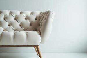 Chic modern sofa with button tufts and angular wooden legs isolated photo