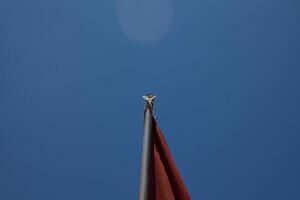 flag on pole with sky background photo