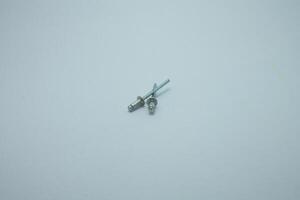 Aluminum rivets on a white background. Sale of rivets and fixing tools. photo