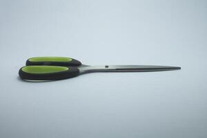 black green handle scissors isolated on white background photo