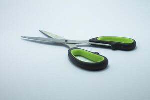 black green handle scissors isolated on white background photo