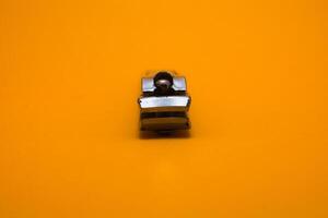 nail clipper isolated on yellow background photo
