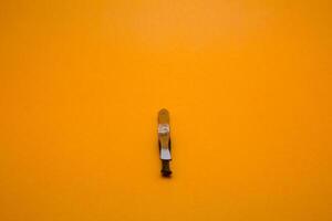 tweezers isolated on yellow background photo