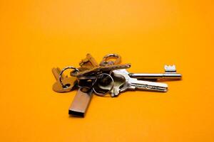 set of keys isolated yellow background photo