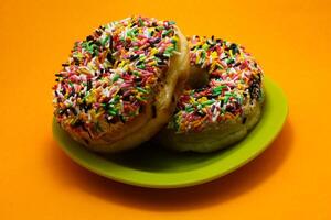 donuts with colorful sprinkles topping photo