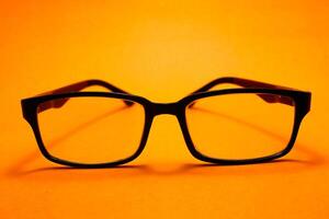 a pair of glasses isolated on yellow background photo