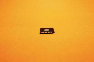 Black SD memory card isolated on yellow background photo