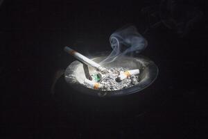 a cigarette on the ashtray photo