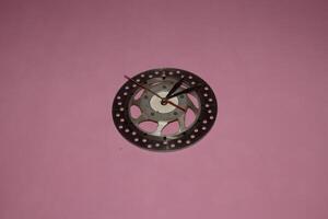 handmade wall clock from used motorcycle discs photo