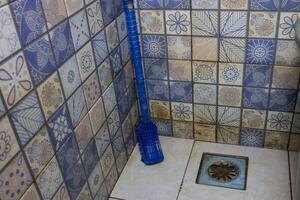 bathroom floor brush in the corner photo