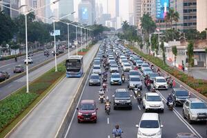 Jakarta traffic jam in the business center and offices main road of Jakarta. Traffic congestion after office hours on weekdays after social restriction of pandemic Covid-19 photo