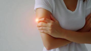 Woman Holding Elbow with Hand in Pain Close Up photo