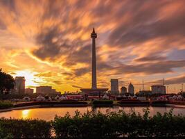 Beautiful landscape of Monas Monument in Medan Merdeka Square, Jakarta in the cloudy sunset in long exposure photography mode photo