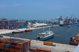 Aerial view of port with cranes and shipping containers, large ships ready for load the cargo photo