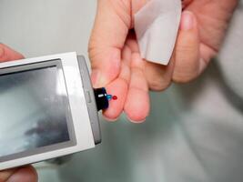 Healthcare and medical concept, The diabetic measures the level of glucose in the blood. photo