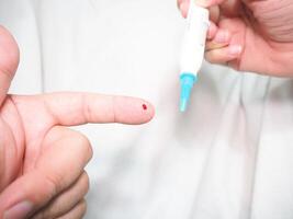 Healthcare and medical concept, The diabetic measures the level of glucose in the blood. photo