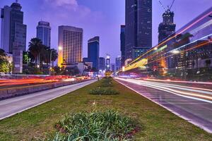 Light trail of cars in the central business and office road in the evening photo