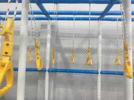 Yellow Handholds on Playground Structure photo