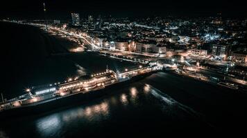 Aerial view of a seaside, Brighton Pier and beach in night lights, Brighton, East Sussex, UK photo