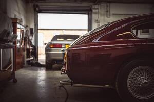 Classic cars being restored in a vintage vehicle garage workshop photo