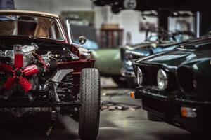 Classic cars being restored in a vintage vehicle garage workshop photo
