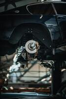 Classic, vintage, British car being restored on a ramp with visible rear axle photo