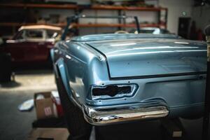 Classic cars being restored in a vintage vehicle garage workshop photo